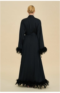Detailed back view of luxury black satin robe with elegant ostrich feather trim on hem