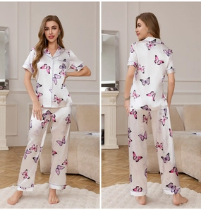 Close-up of silk pajamas with butterfly print featuring a notched collar and purple piping