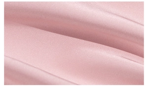 Close-up of premium pink satin fabric showing elegant silk texture and draped folds