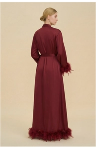 Detailed back view of luxury burgundy satin robe with elegant feather trim on sleeves and hem