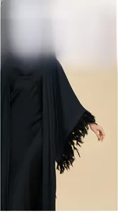 Detailed close-up of luxurious black silk robe cuffs featuring elegant feather trim decoration