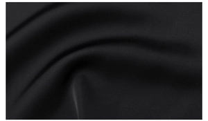 Macro shot of premium black knit fabric with delicate texture and soft drape detail