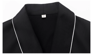 Detail of black pajama top with white piping and lapel collar for women