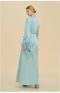 Detailed view of elegant light blue satin robe featuring luxurious feather trim on cuffs