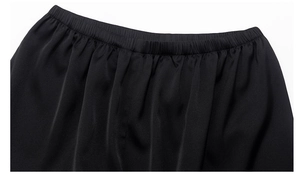 Detail view of the elastic waistband and pleated texture of black loungewear set