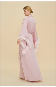 Luxurious pink satin robe detail featuring elegant fluffy feather trim on wide cuffs