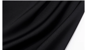 Macro shot of elegant black satin fabric showing smooth texture and soft drape of pajamas