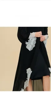 Detail view showing white floral lace trim on black chiffon robe sleeves and hemline
