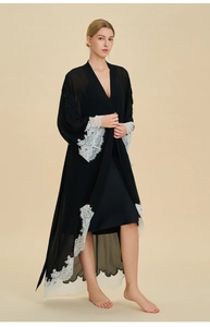Detailed view of black chiffon robe with contrast white lace trim and silk slip dress