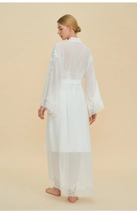 Detailed embroidery on cuffs of white chiffon robe with elegant lace trim details