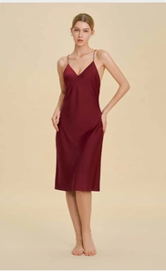 Detail of silk satin burgundy nightdress with deep V-neck and thin shoulder straps