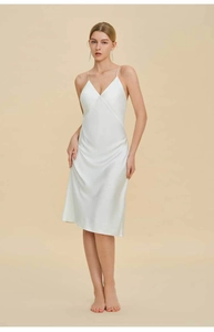 Close-up of elegant white satin slip dress featuring a smooth pearl-like finish and V-neckline