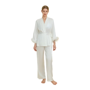 Elegant white satin pajama set with long sleeves and feather trim on cuffs