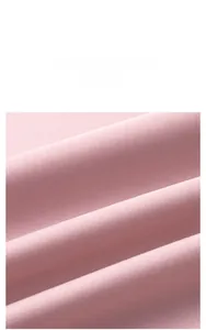 Close-up of pink textile fabric showing smooth texture and soft sheen of the pajama set