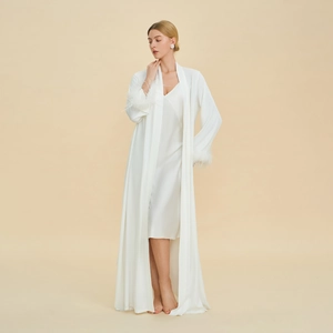 Elegant white two-piece satin sleepwear set featuring long robe with feather trim cuffs