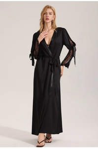 Detailed close-up of a black satin robe featuring lace sleeves and elegant bow tie details