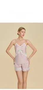 Detailed view of women's silk pajamas with delicate lace trim on hem and neckline