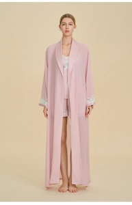 Detailed view of women's 3-piece pink pajama set with elegant white lace trim on sleeves