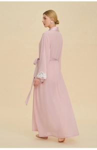 Detailed view of pale pink satin robe with delicate white lace cuffs and waist tie