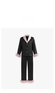 Detail of luxury satin pajama set featuring detachable pink feather trim on sleeves