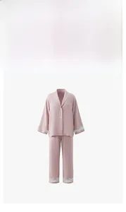 Close-up of pink satin pajama set featuring delicate white lace trim on cuffs and hems