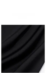 Close-up of premium black pajama fabric with a smooth matte silk texture and elegant drape