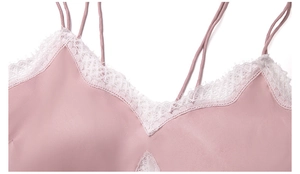 Close-up of pink satin camisole top featuring delicate white lace trim and thin straps