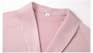 Detail of pink satin sleepwear neckline with smooth seams and size S tag shown