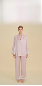 Pale pink silk satin pajamas set with lace trim on sleeves and hem for women