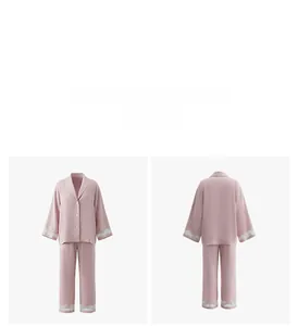 Detail view of light pink pajamas set with white lace cuffs and button-down V-neck collar