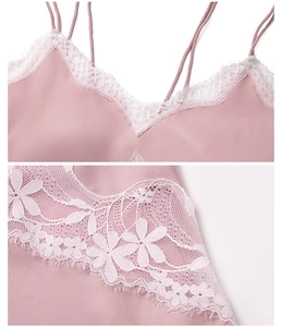 Détail du caraco en satin rose avec dentelle florale blanche et fines bretelles doubles