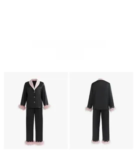 Detail of luxury pajama set with detachable pink feathers and satin lapel on black fabric