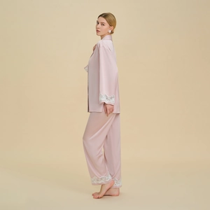 Lace-trimmed pale pink satin pajama set with long sleeves and wide-leg pants for women