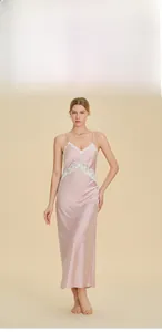 Detail view of pink satin nightgown with white lace V-neckline and elegant silk-like texture