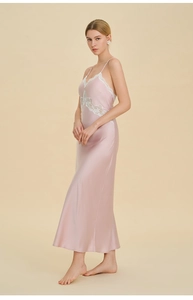 Detail showing delicate white lace embroidery on a light pink silk long nightgown dress