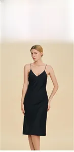 Detail of elegant black satin sleepwear dress with slim straps and V-neckline finish