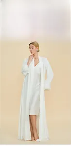 Detail of silk satin two-piece sleepwear with feather cuffs and elegant long robe