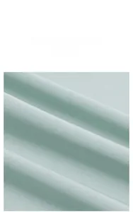 Macro shot of mint green luxury satin fabric with smooth silk texture and drape