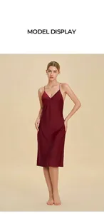 Detail of burgundy satin slip dress showing the v-neck design and smooth silky texture