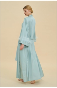 Detailed view of light blue satin robe featuring luxurious feather trim on long sleeves