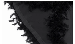 Detail of luxury long robe featuring premium black feather trim on sleeve edges