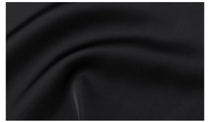 Macro shot of premium black satin fabric texture with smooth silk-like folds for luxury robes