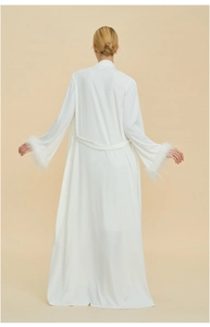 Back view of a white satin robe with luxurious feather cuffs and waist tie detail