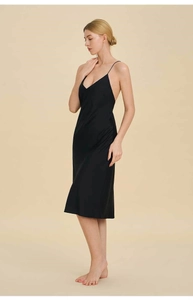 Detail of elegant black satin nightdress with slim straps and smooth silk texture