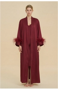 Detailed view of luxury burgundy satin pajamas set with elegant feather trim on sleeves