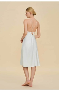 Detail of cross-back straps and silky satin fabric on a white backless nightgown