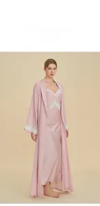 Detail of pink silk-like robe set with elegant white lace trim and satin nightgown