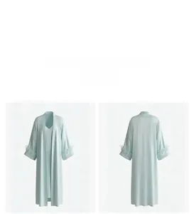 Detail view of light blue satin pajama set with elegant feather trim on sleeve cuffs