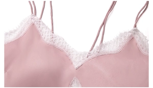 Close-up of pink satin nightgown featuring delicate white lace trim and thin straps