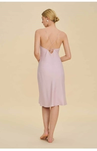 Rear view of pink satin slip dress featuring elegant cross-back straps and open back detail